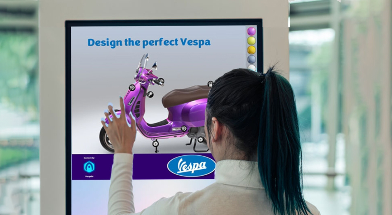 woman customizing a Vespa scooter on an interactive touchscreen kiosks powered by BrightSign digital media players