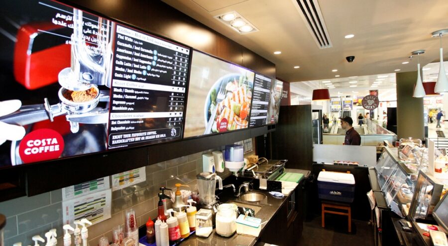 Costa Coffee counter prep area and digital menu board